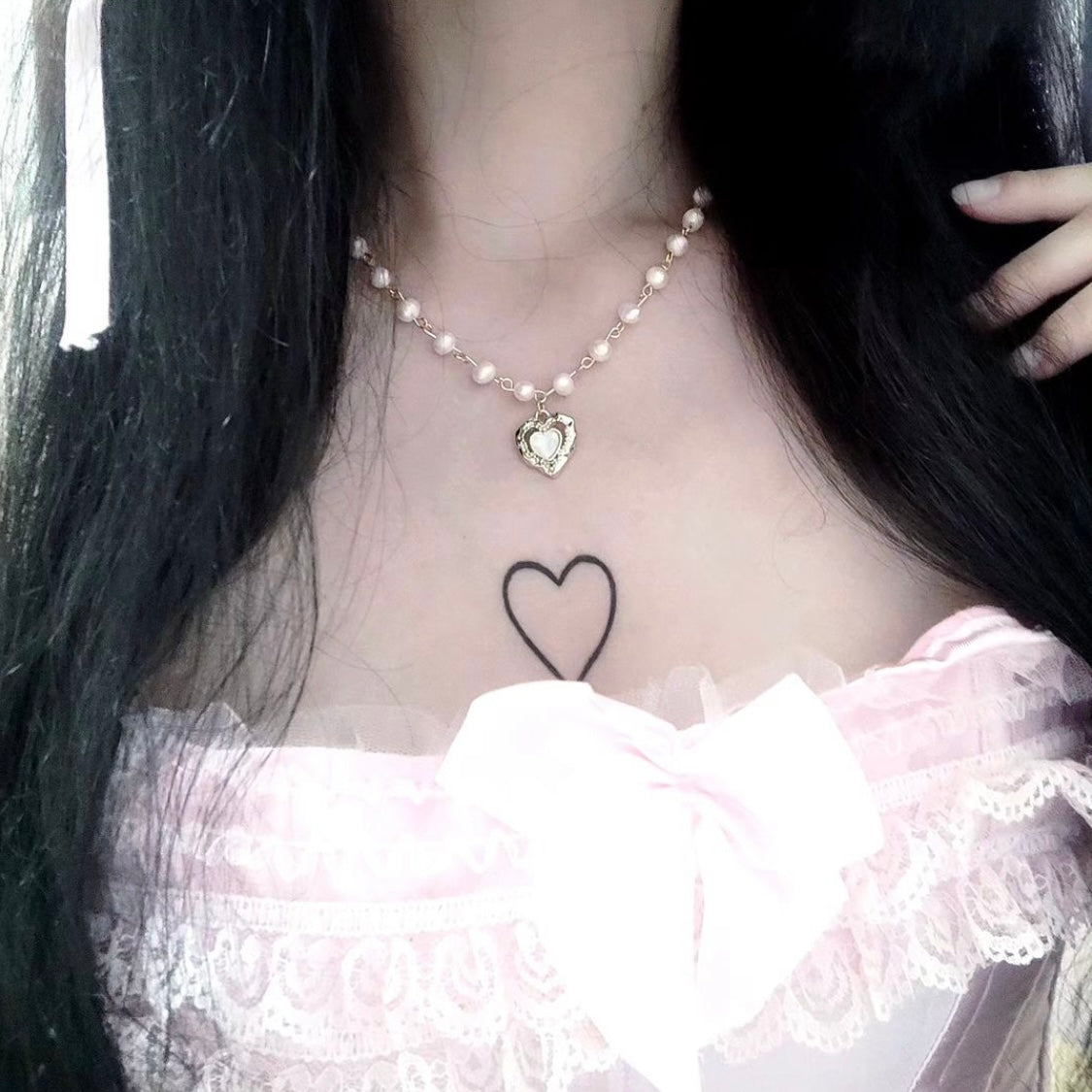 Pearl choker with a gold heart pendant, inspired by Vivienne Westwood’s iconic bridal and vintage jewelry aesthetic.