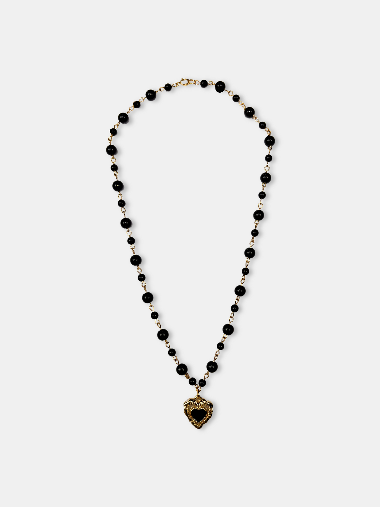 Gothic black onyx choker with gold-plated heart pendant, perfect for soft goth and dark feminine fashion.