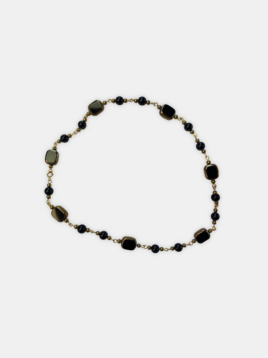 Black onyx choker with square-shaped gemstone beads and gold-plated accents, perfect for gothic and alternative fashion.