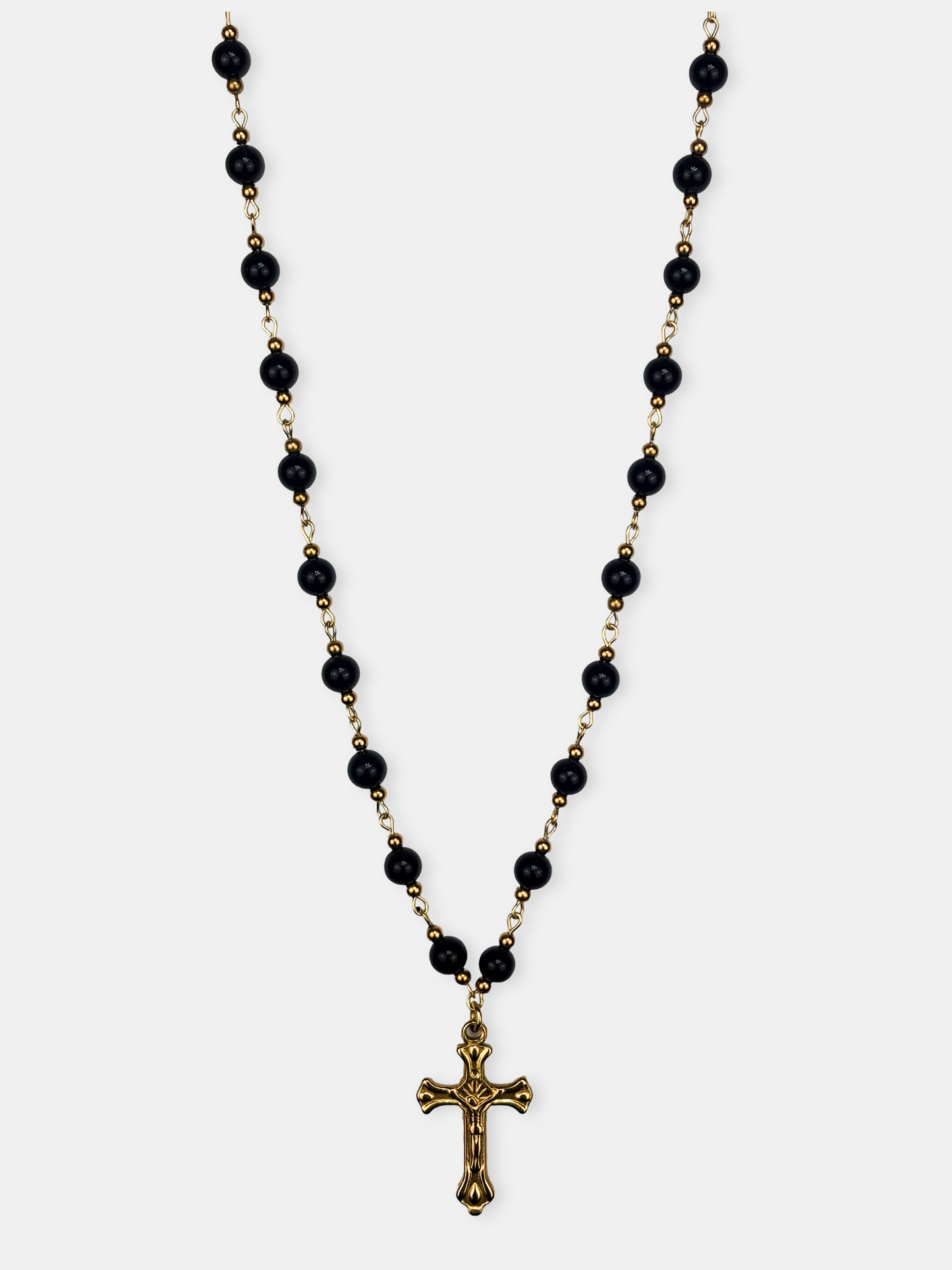 Dark aesthetic black onyx necklace with a gold crucifix, a unique blend of elegance and gothic style.