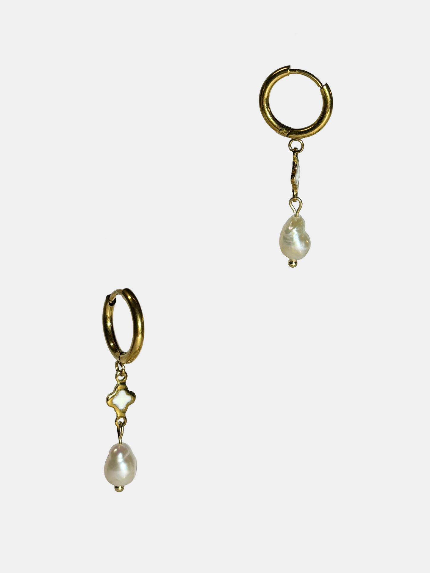 Minimalist gold hoop earrings adorned with organic-shaped freshwater pearls and clover motif.