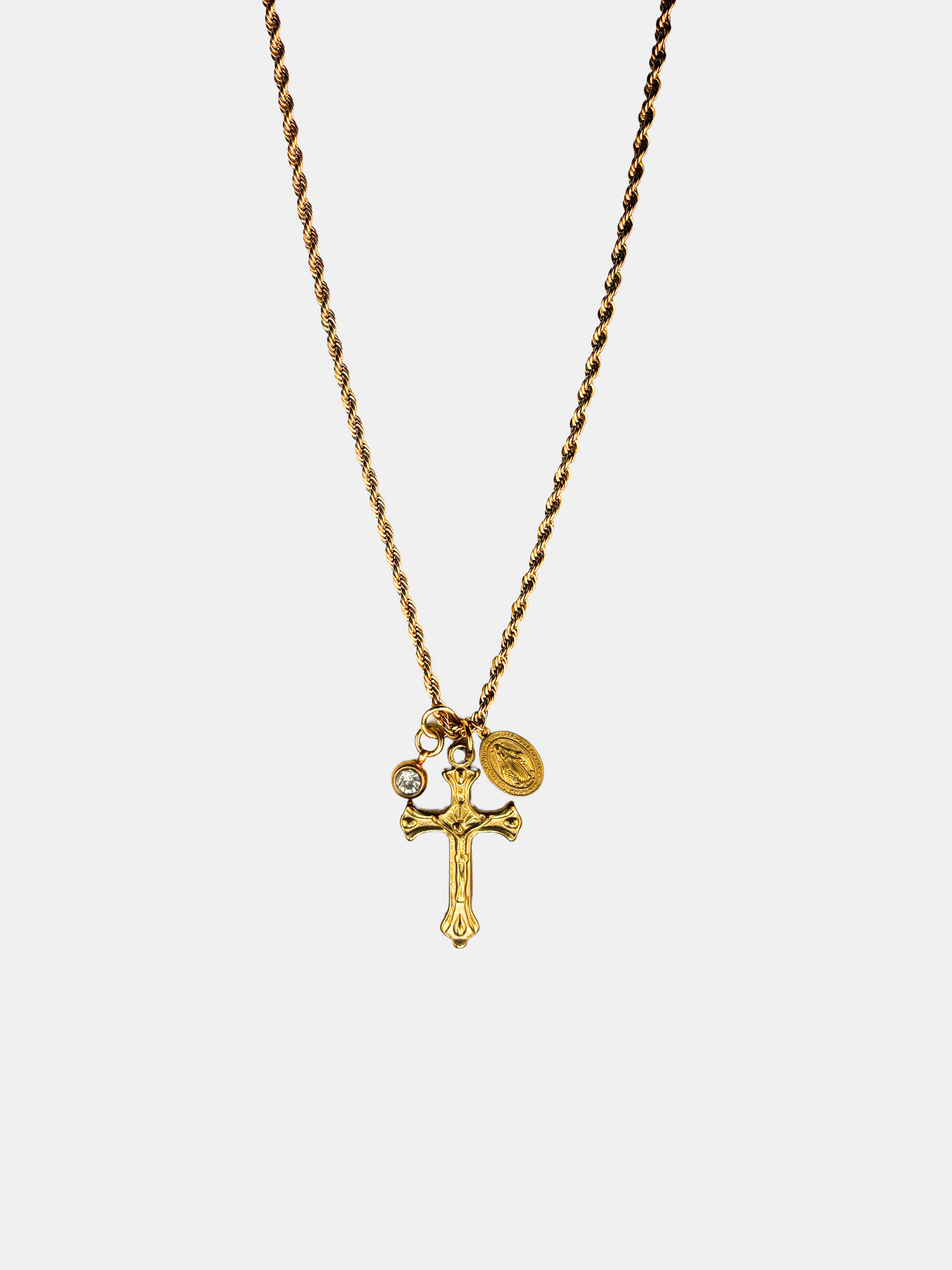 Elegant gold-plated crucifix charm necklace with a vintage-inspired design, featuring a small Christian cross pendant and a dainty Catholic Miraculous Medal.