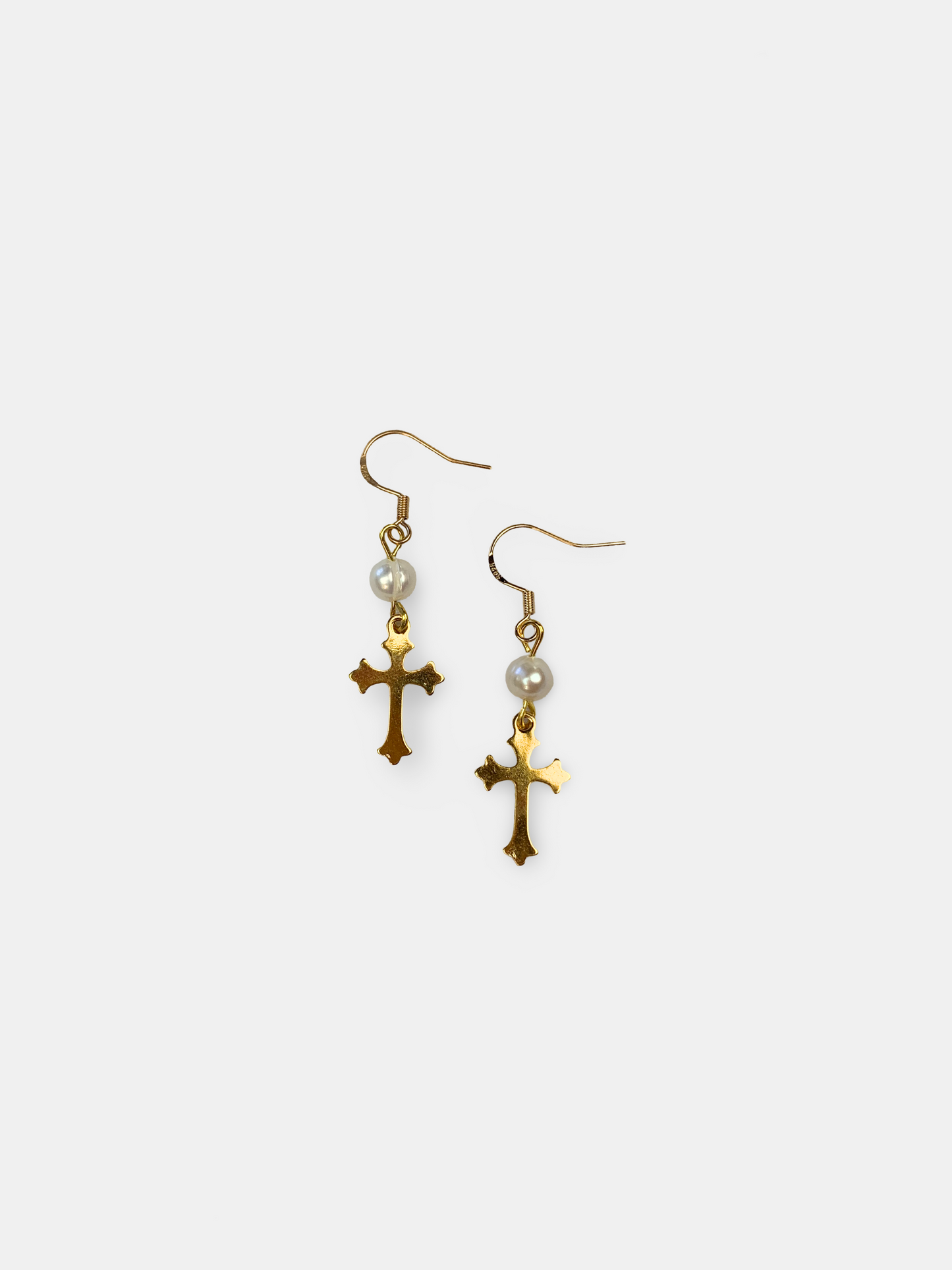 Gold cross dangle earrings featuring genuine pearls, a vintage-inspired accessory with timeless charm.