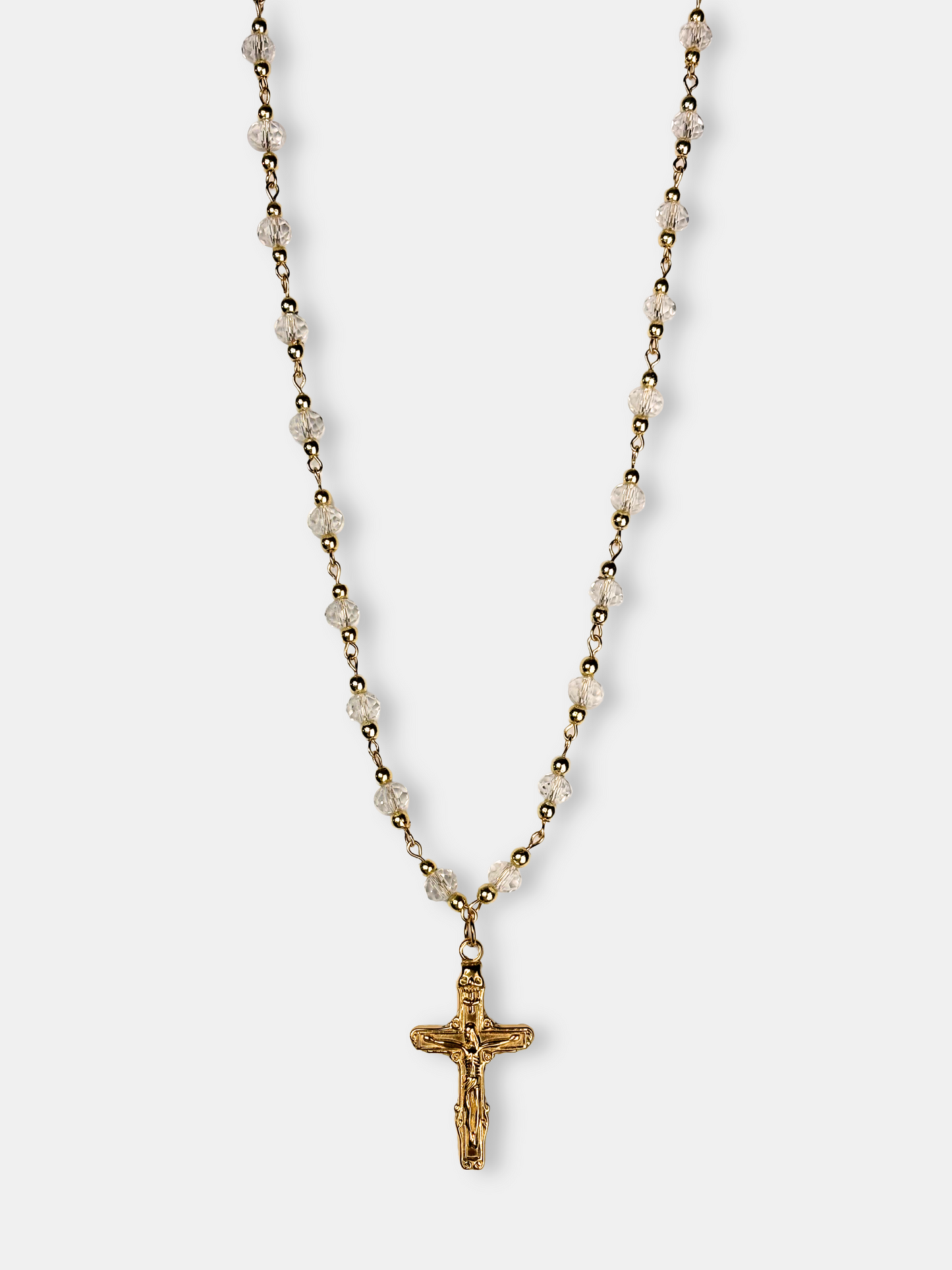 Elegant gold necklace with faceted clear crystal beads and a detailed gold cross pendant, perfect for vintage and gothic styles.