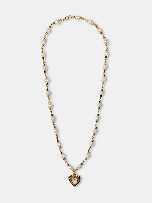 Romantic vintage-inspired pearl necklace with a gold heart charm, featuring delicate baroque pearls.