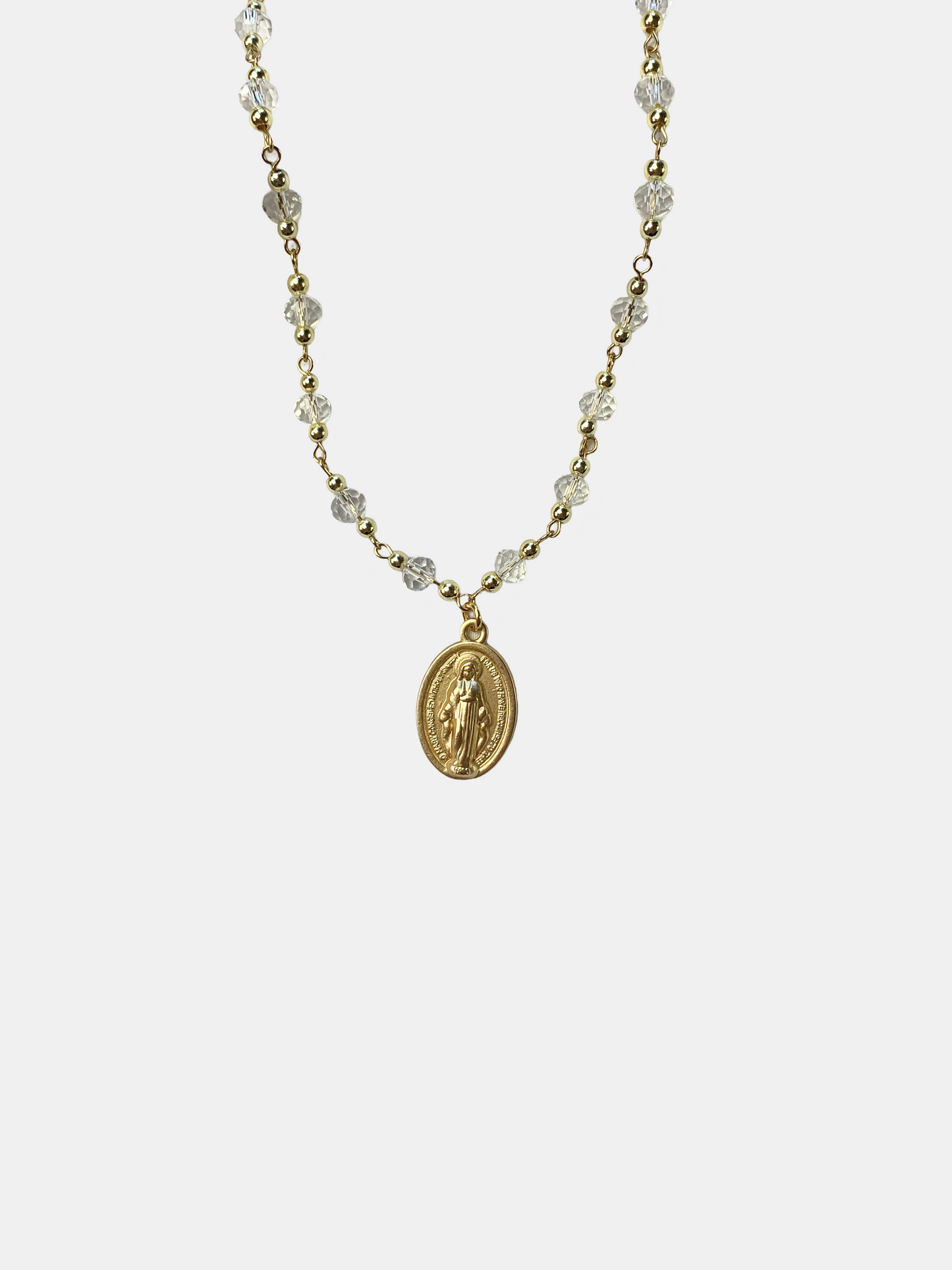 Gold and clear crystal necklace with a detailed Virgin Mary medal, symbolizing faith and devotion.