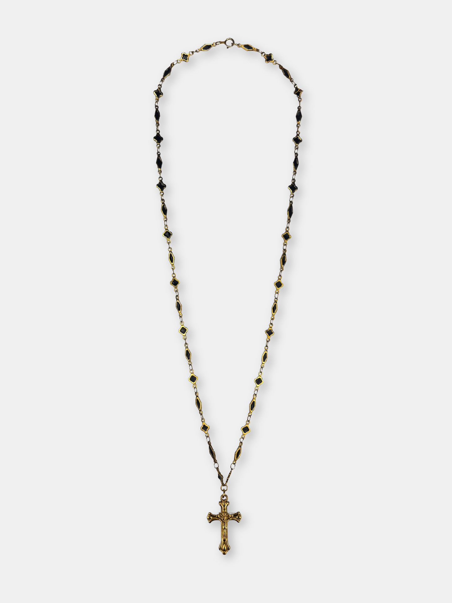Vintage-inspired gold cross pendant on a delicate long black and gold chain, perfect for gothic and baroque fashion lovers.