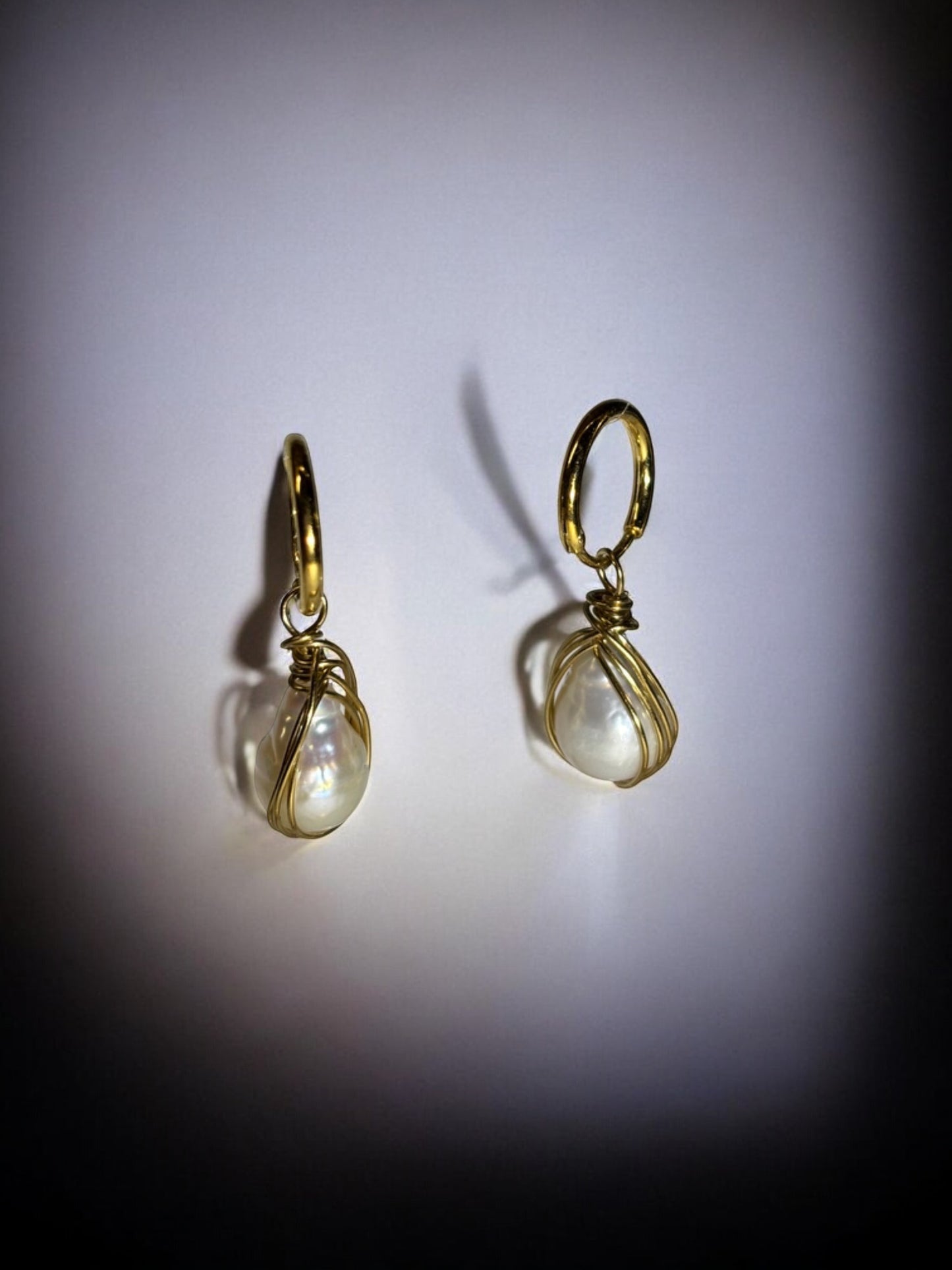 Handmade gold and pearl drop earrings showcasing the natural luster of genuine freshwater pearls.