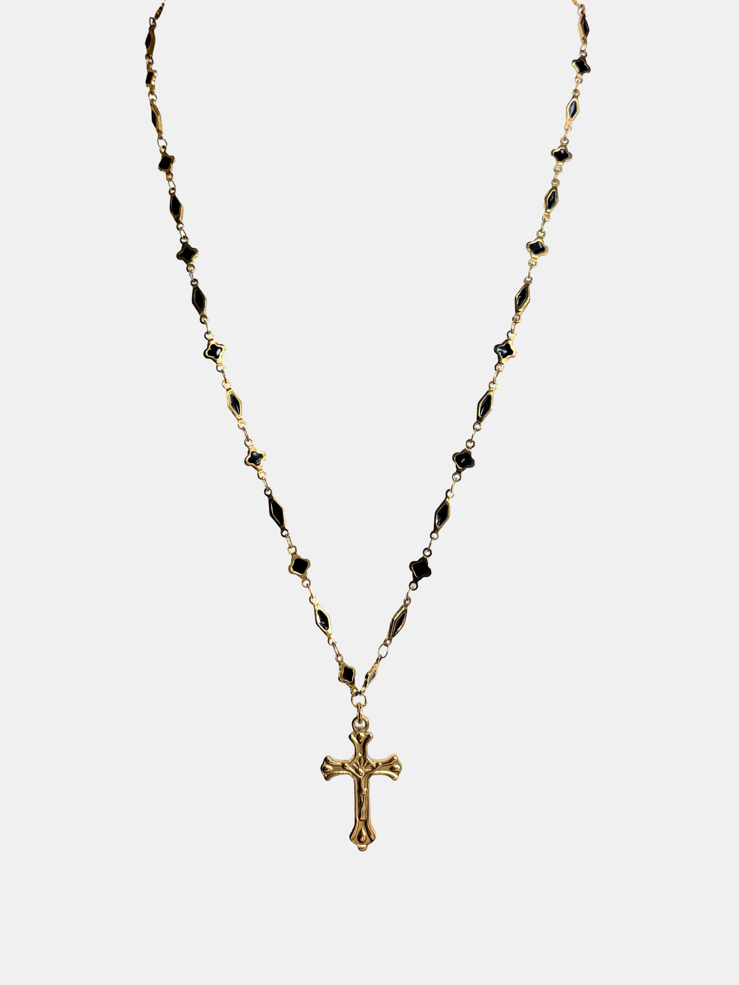 Gothic gold cross necklace with a long chain, evoking antique rosary influences for a timeless, elegant look