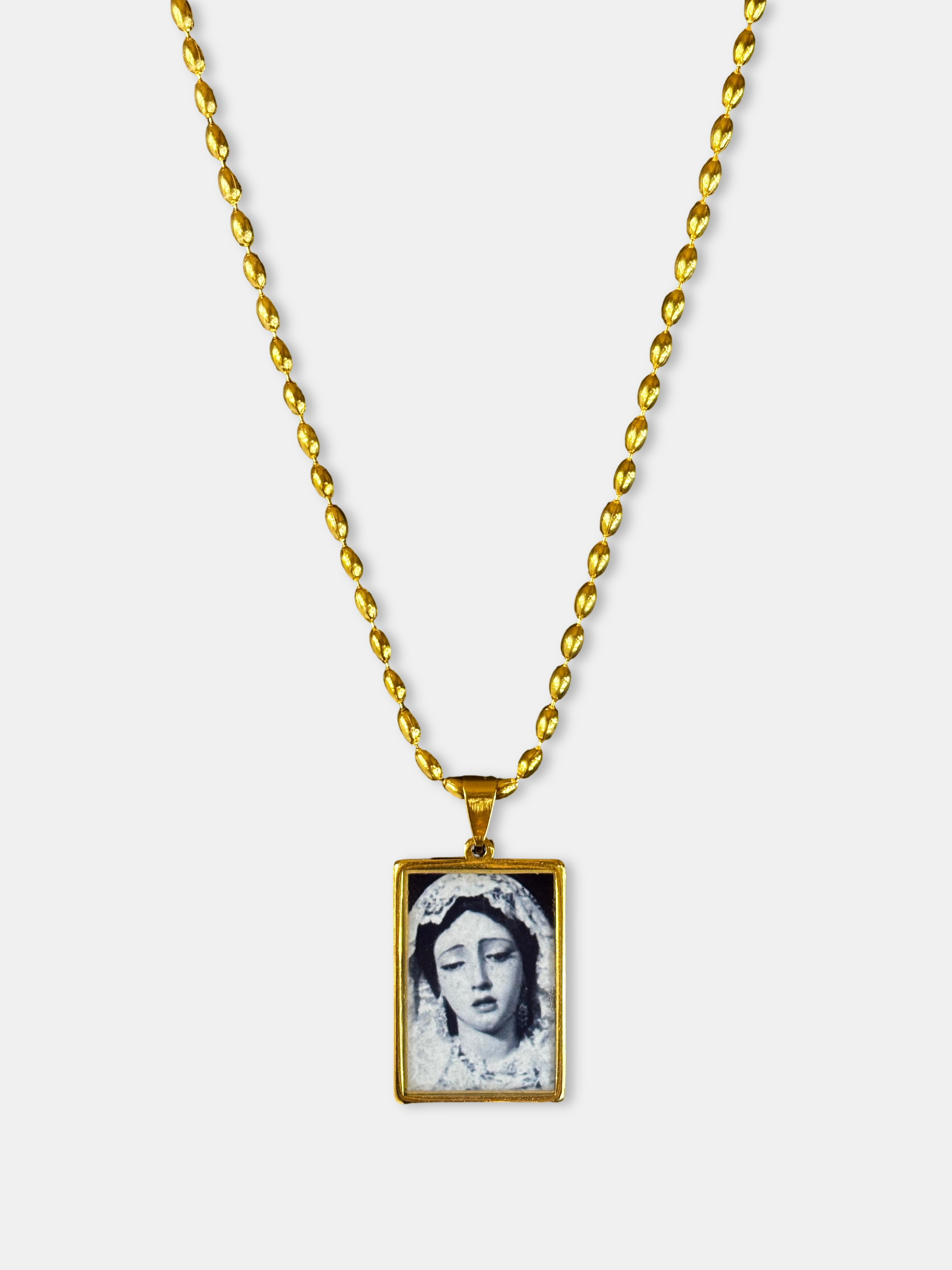 Rectangular gold necklace with black and white Virgin Mary illustration