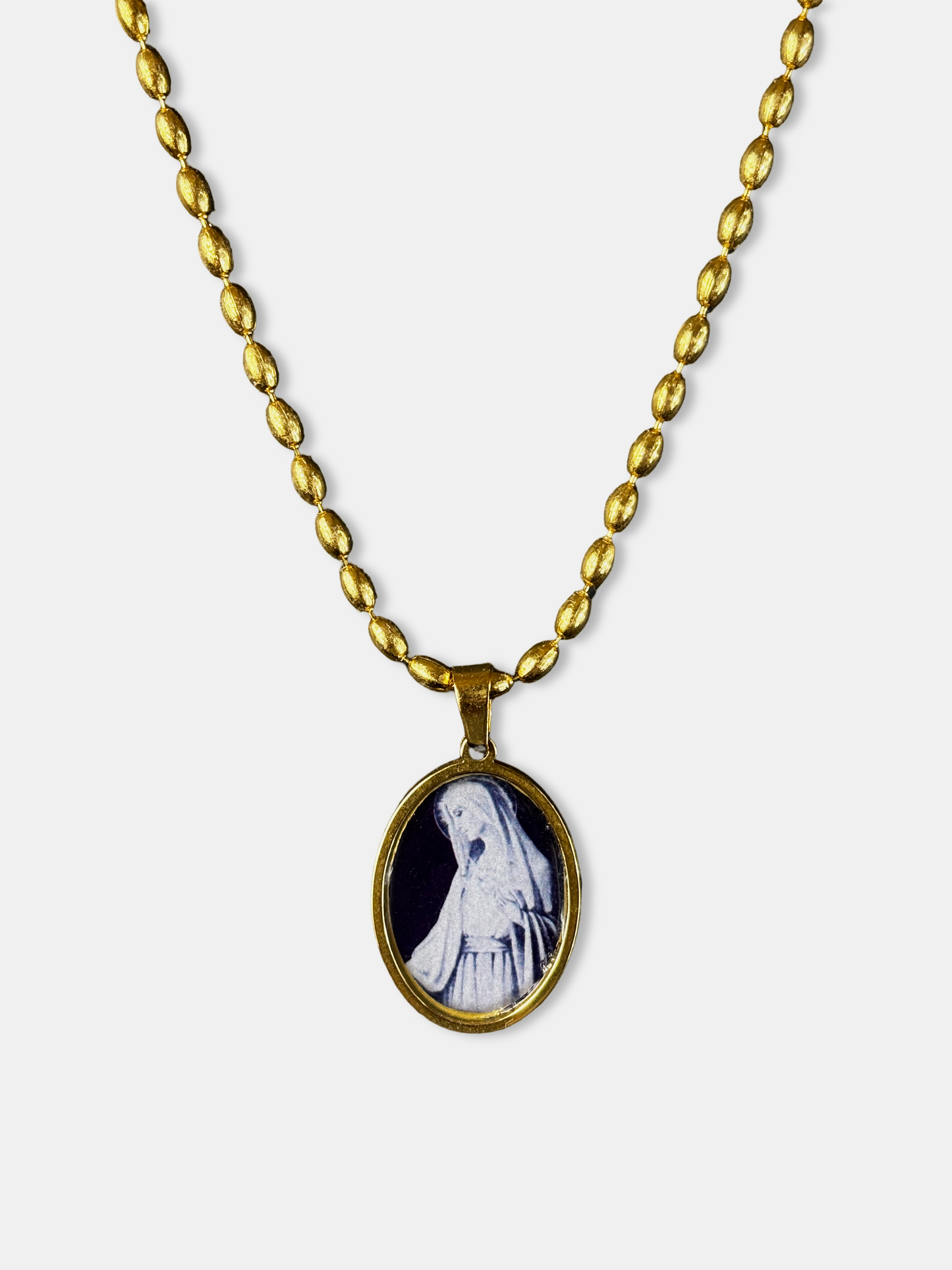 Gold medallion with a miniature oval pendant showing the Virgin Mary, inspired by sacred art.
