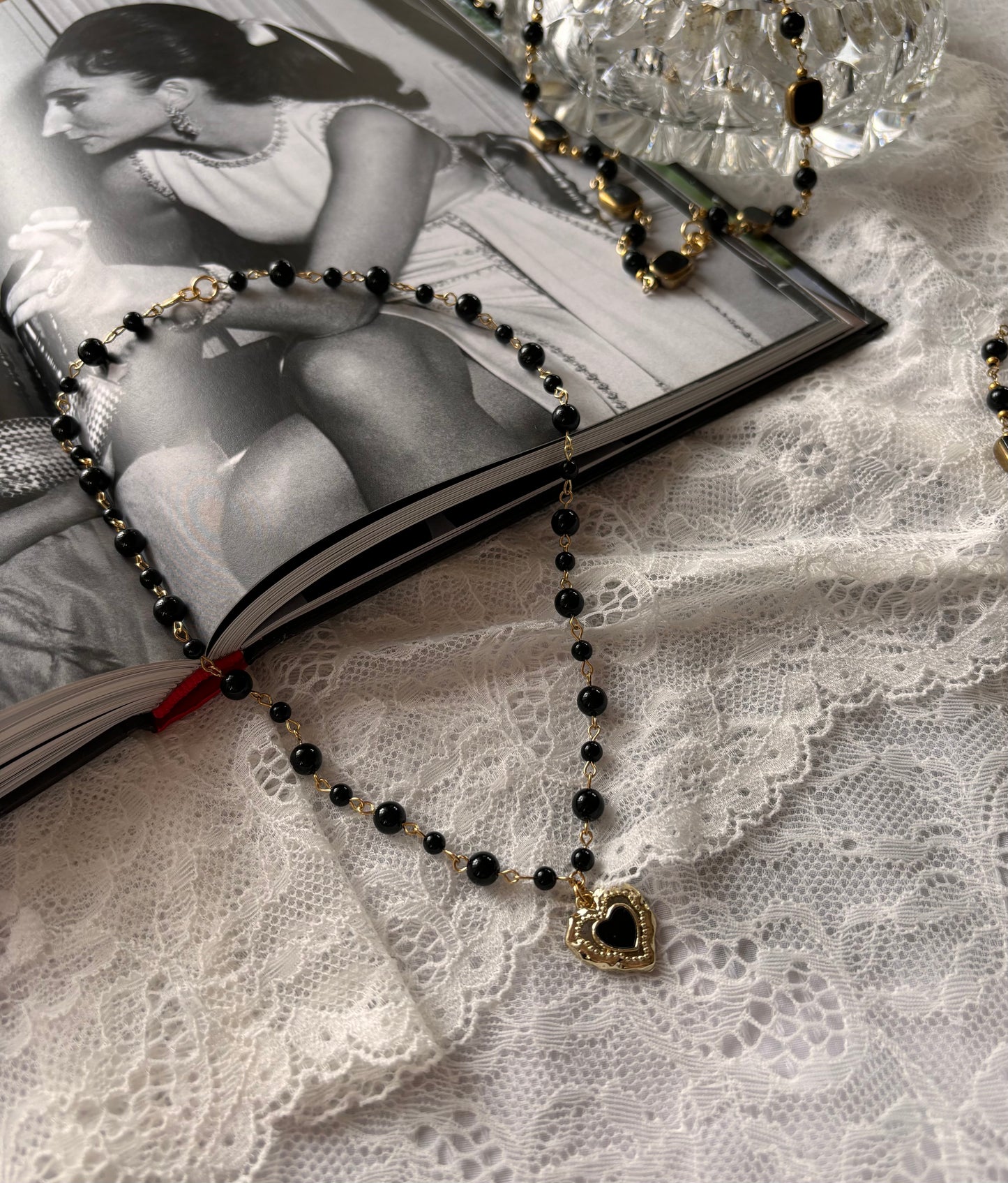 Dark feminine jewelry piece – black onyx choker with a romantic vintage-style gold heart pendant.