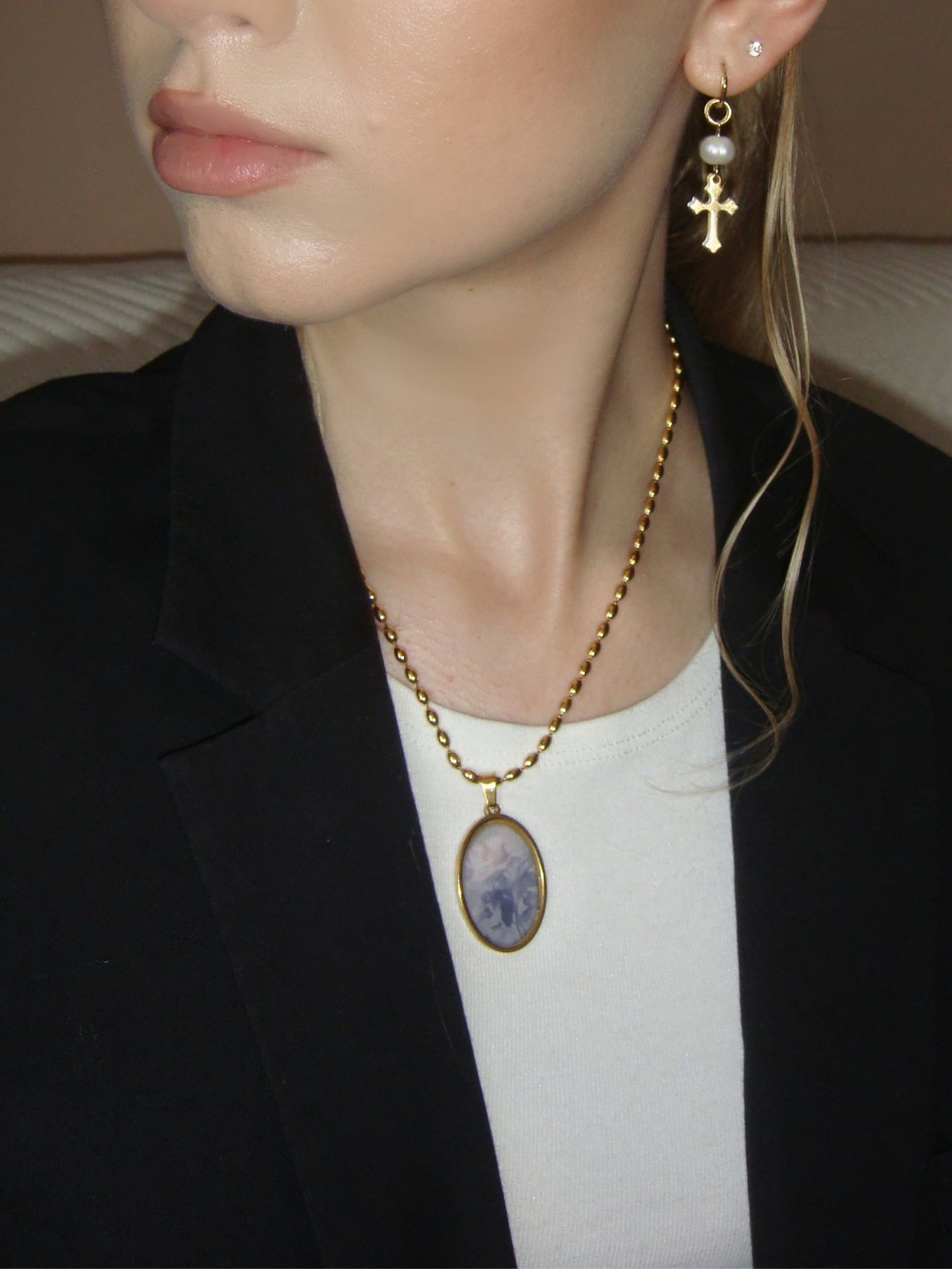 Delicate gold necklace showcasing a vintage-style oval pendant with a rose motif.