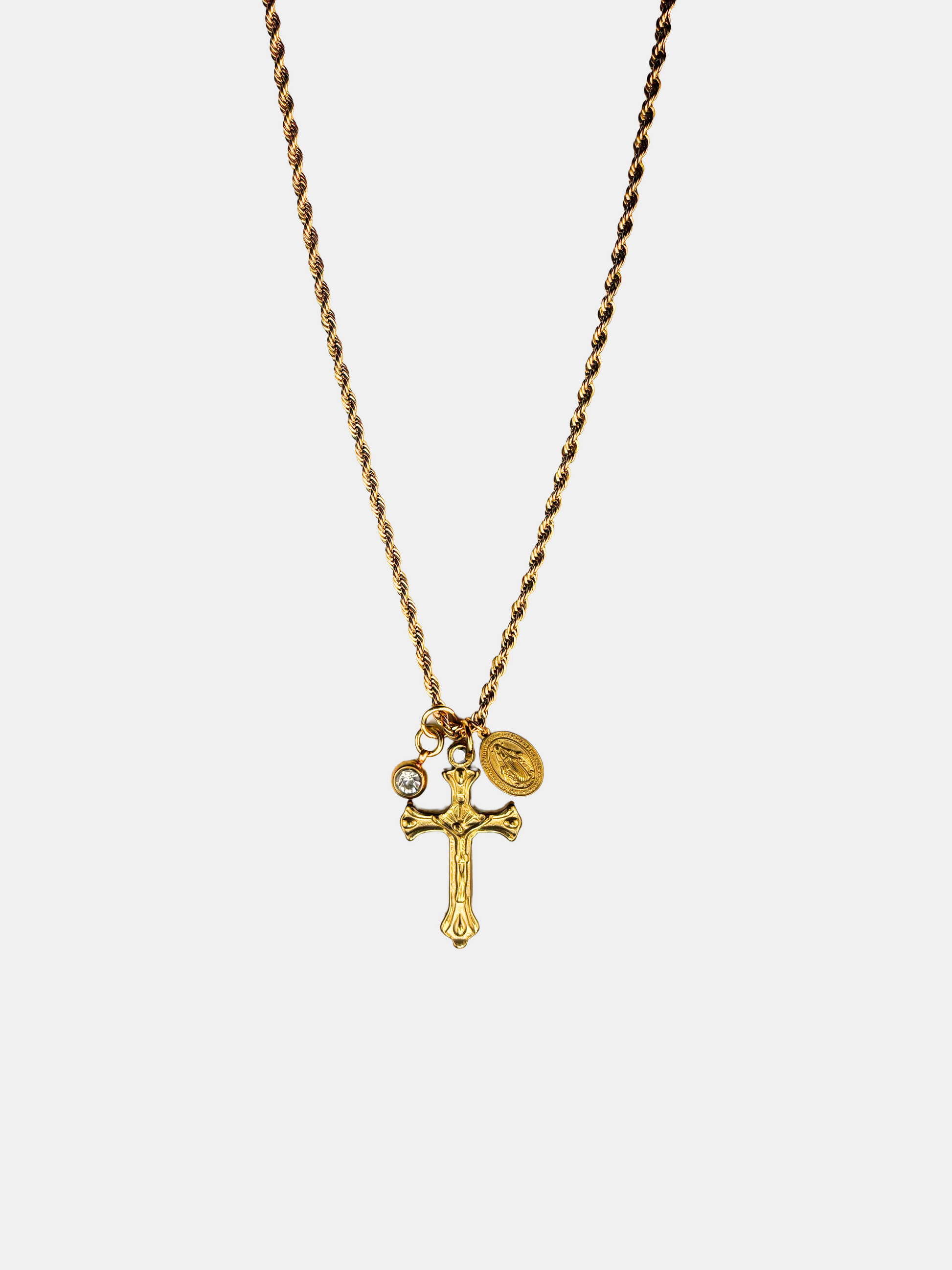Elegant gold-plated crucifix charm necklace with a vintage-inspired design, featuring a small Christian cross pendant and a dainty Catholic Miraculous Medal.