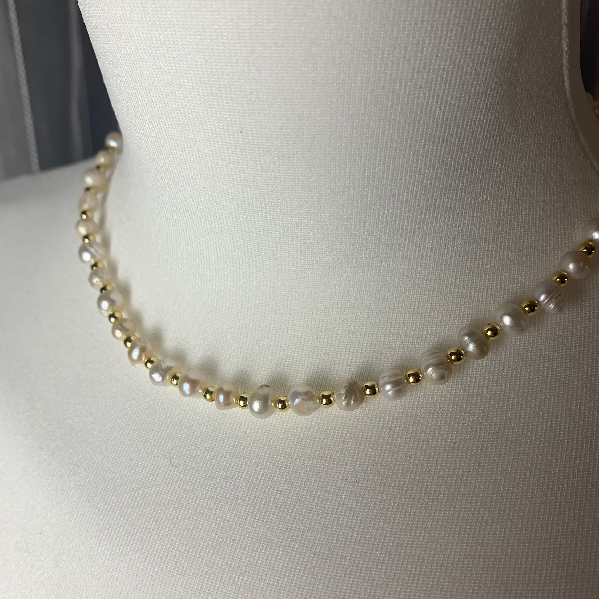 Artisan pearl necklace with irregular pearls and gold detailing, inspired by vintage luxury and timeless elegance.