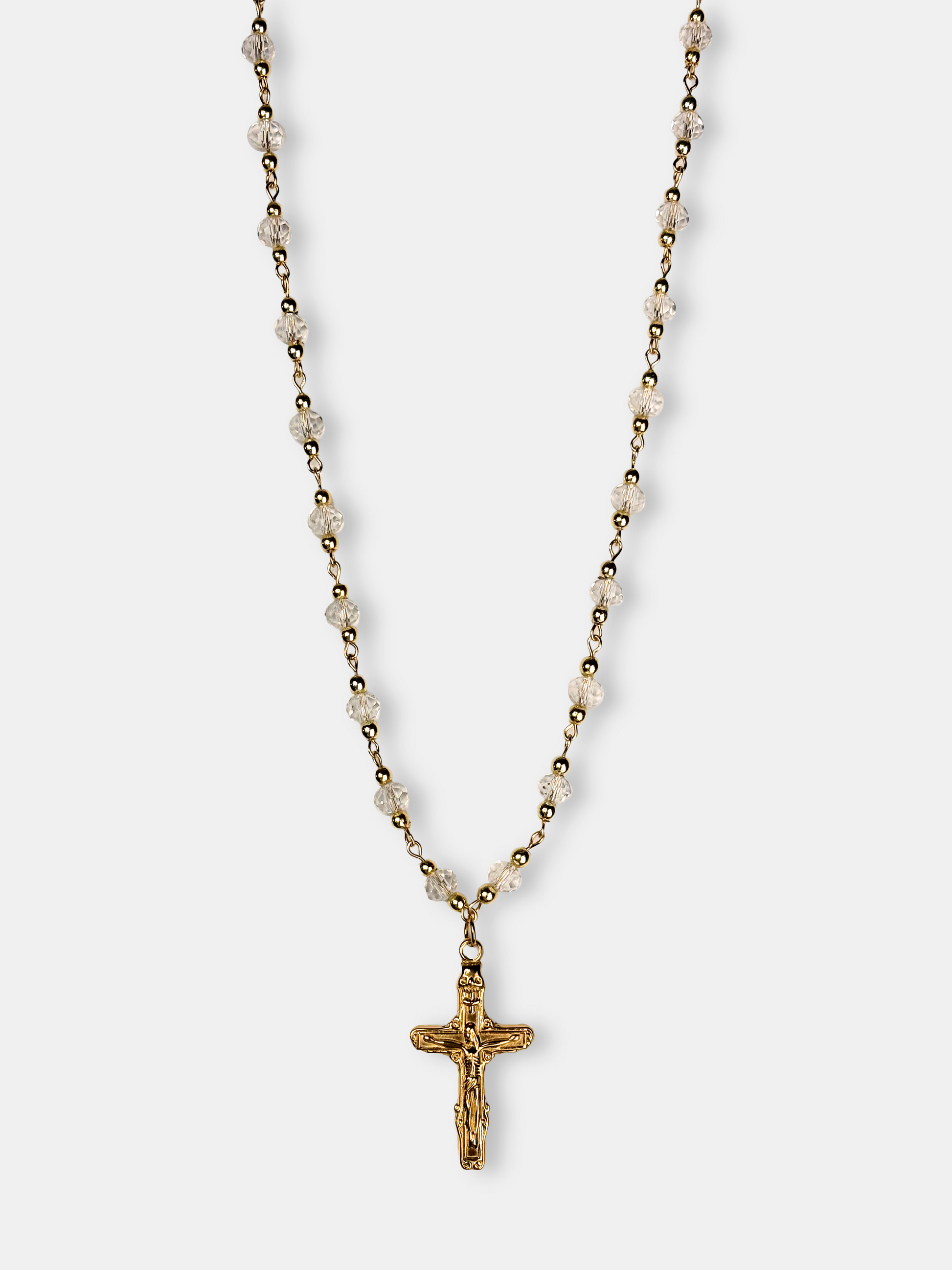 Elegant gold necklace with faceted clear crystal beads and a detailed gold cross pendant, perfect for vintage and gothic styles.