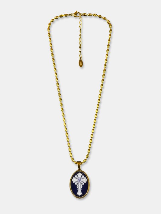 Oval cross pendant necklace with gold-filled chain and black enamel background.