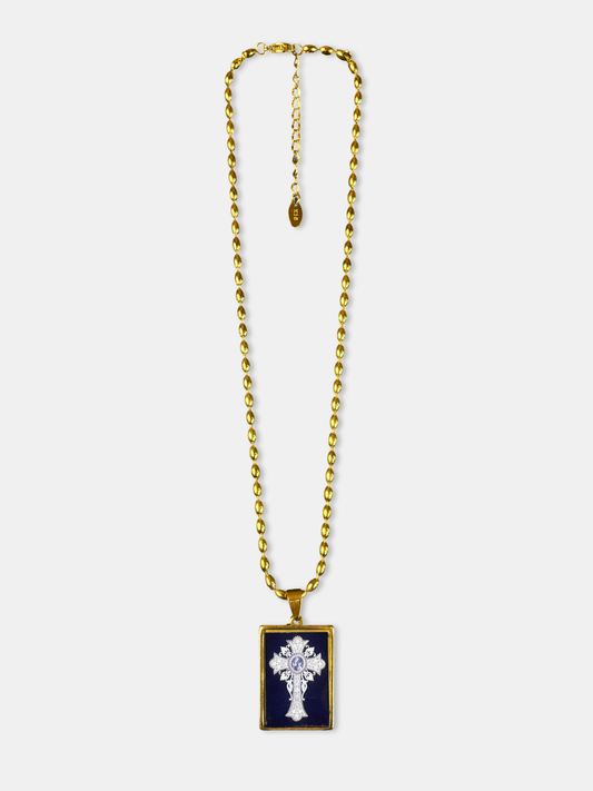 Gold-filled necklace with a vintage-style cross illustration beneath a glossy, glass-like dome.