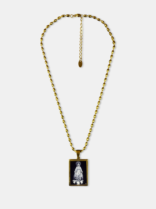 Elegant gold-filled necklace with black enamel pendant depicting the Virgin Mary in white detail.