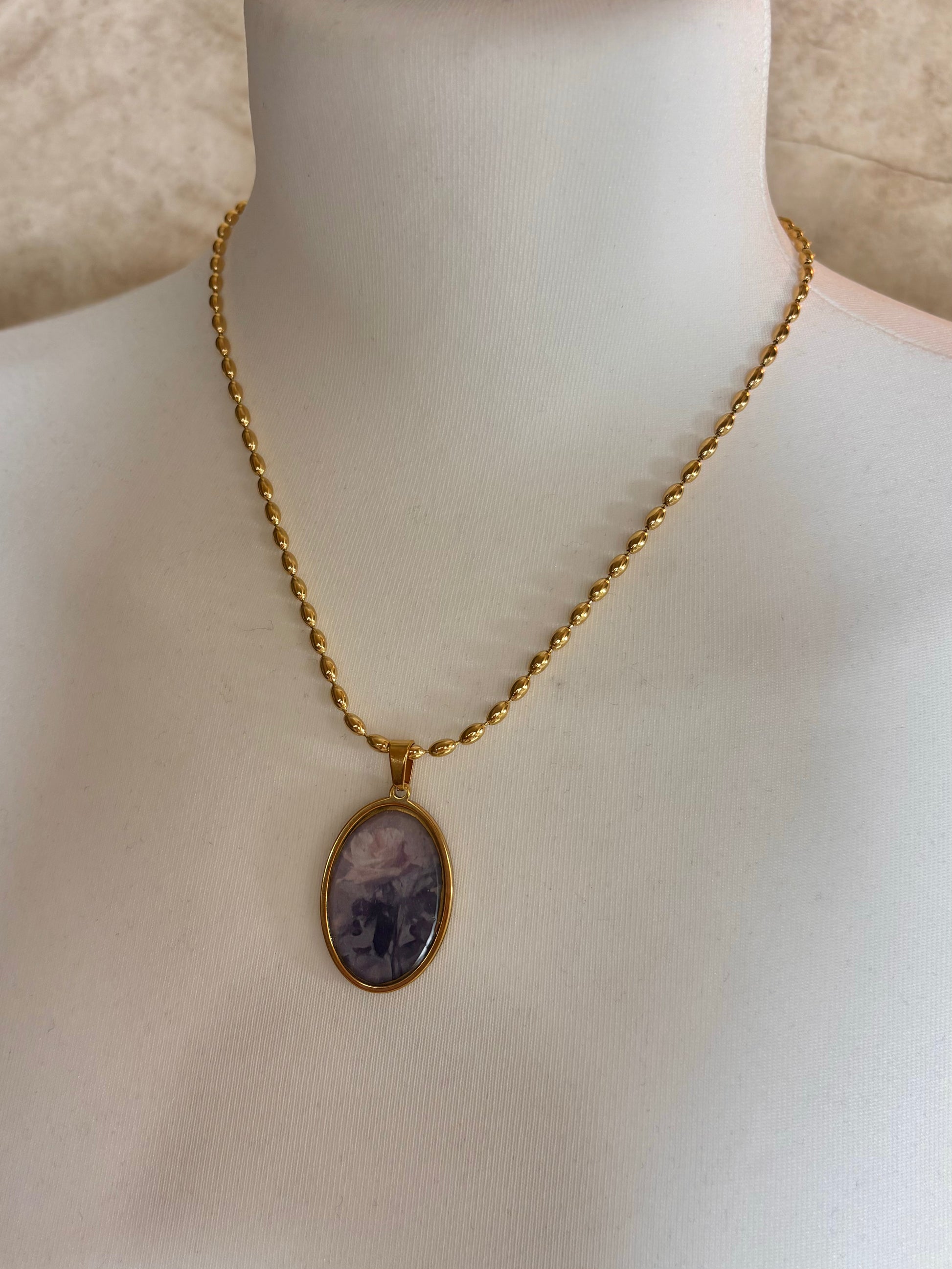 Vintage oval rose pendant necklace in gold.