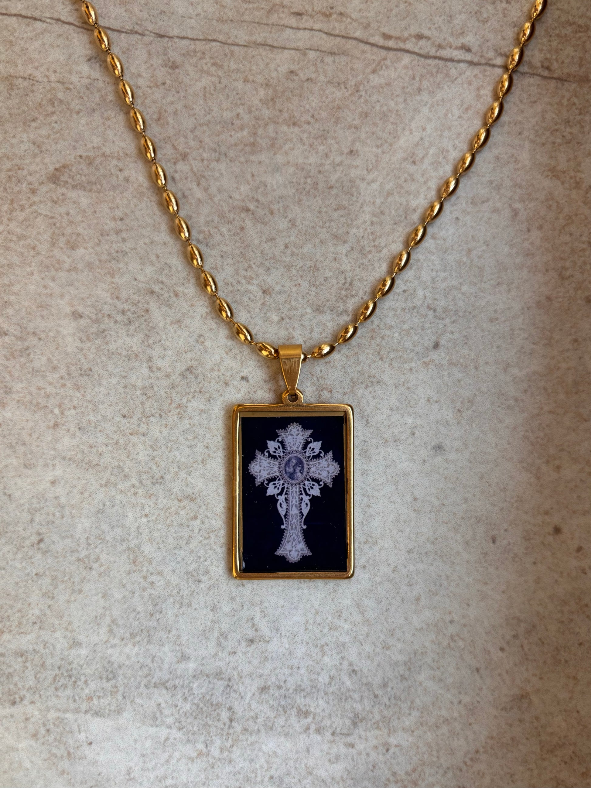 Artistic cross pendant necklace in gold and black tones