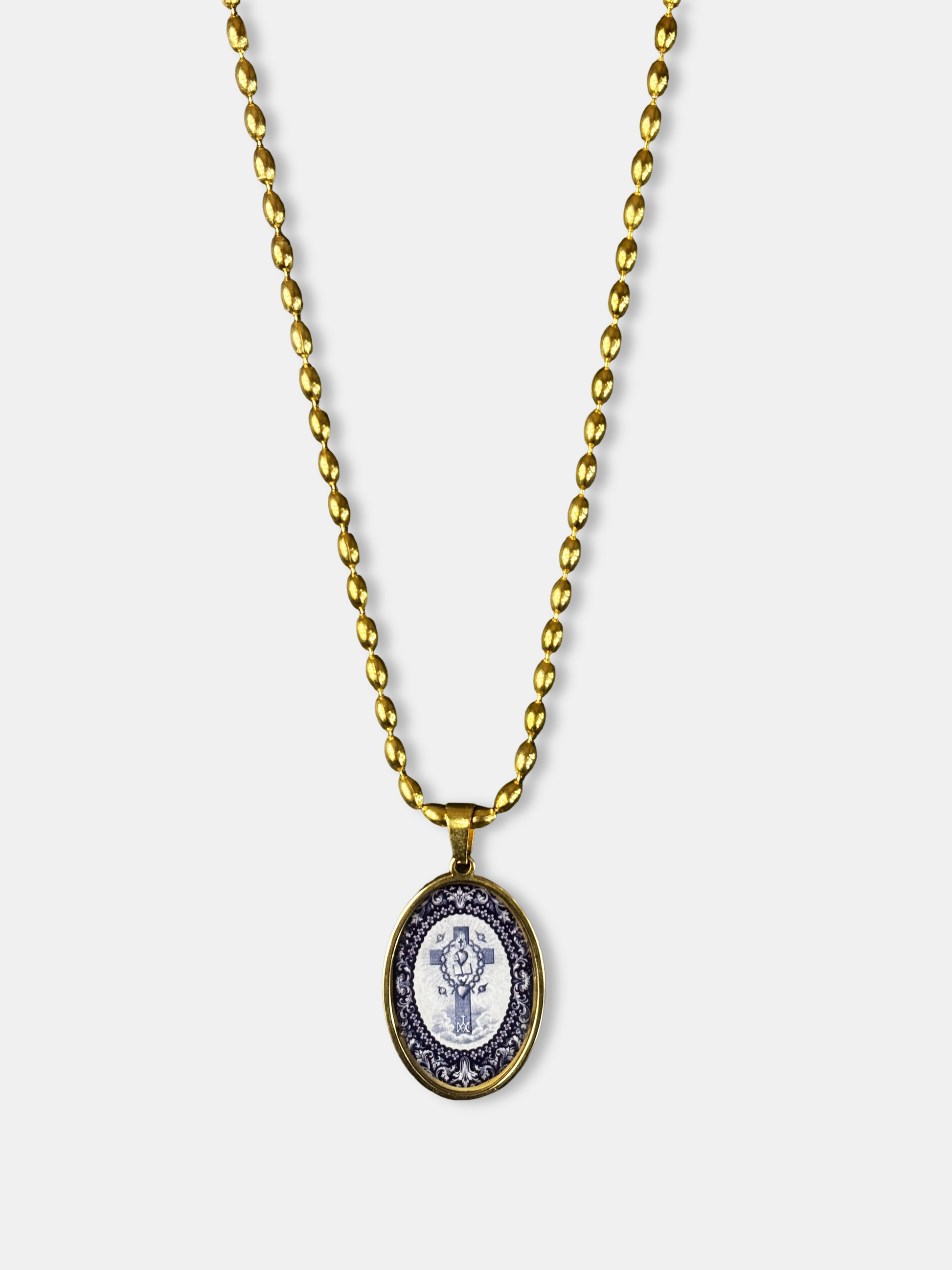 Handmade gold necklace with oval pendant depicting a sacred tree in black and white tones.