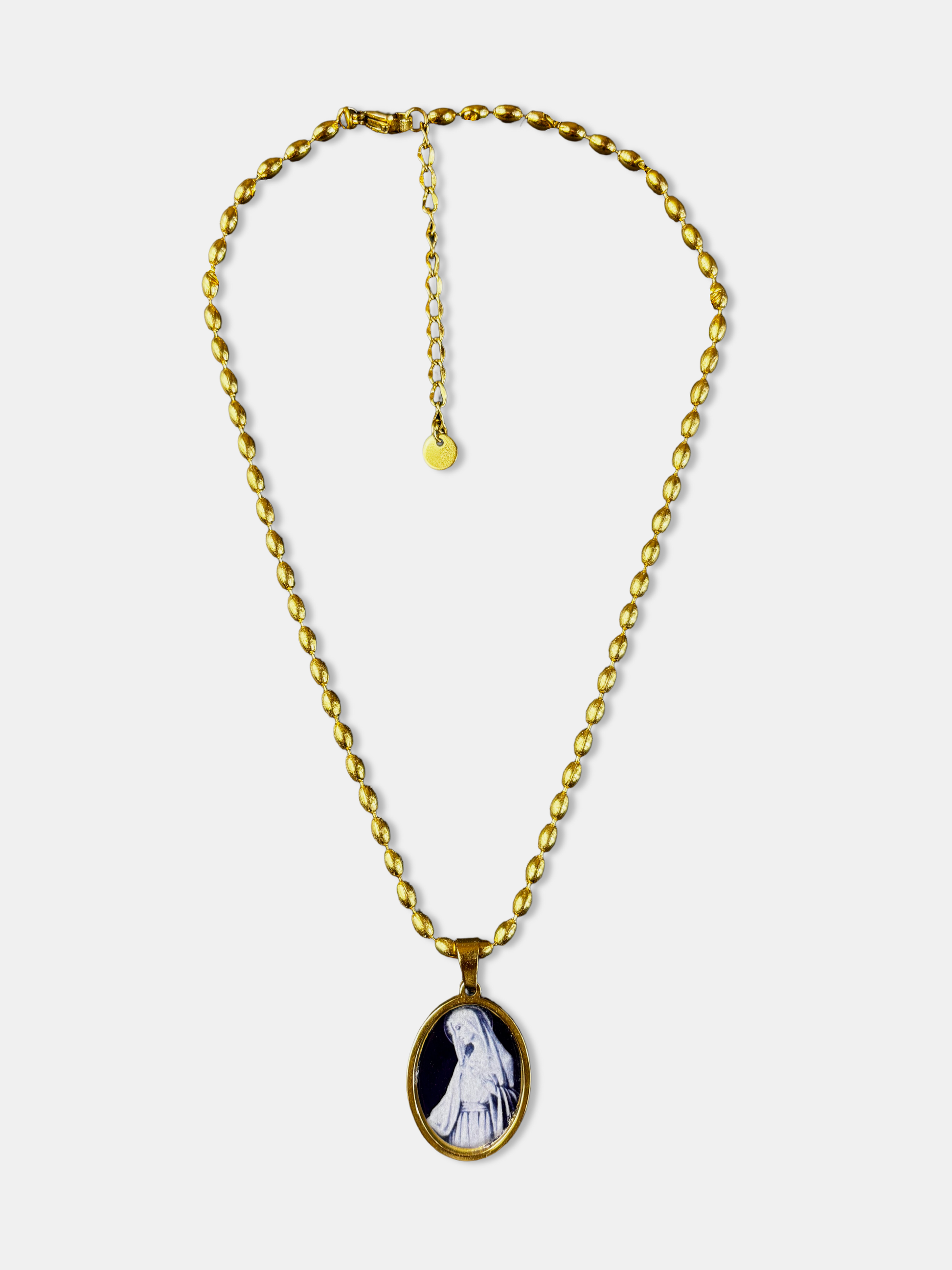 Gothic necklace with small oval pendant depicting the Virgin Mary on a black background.