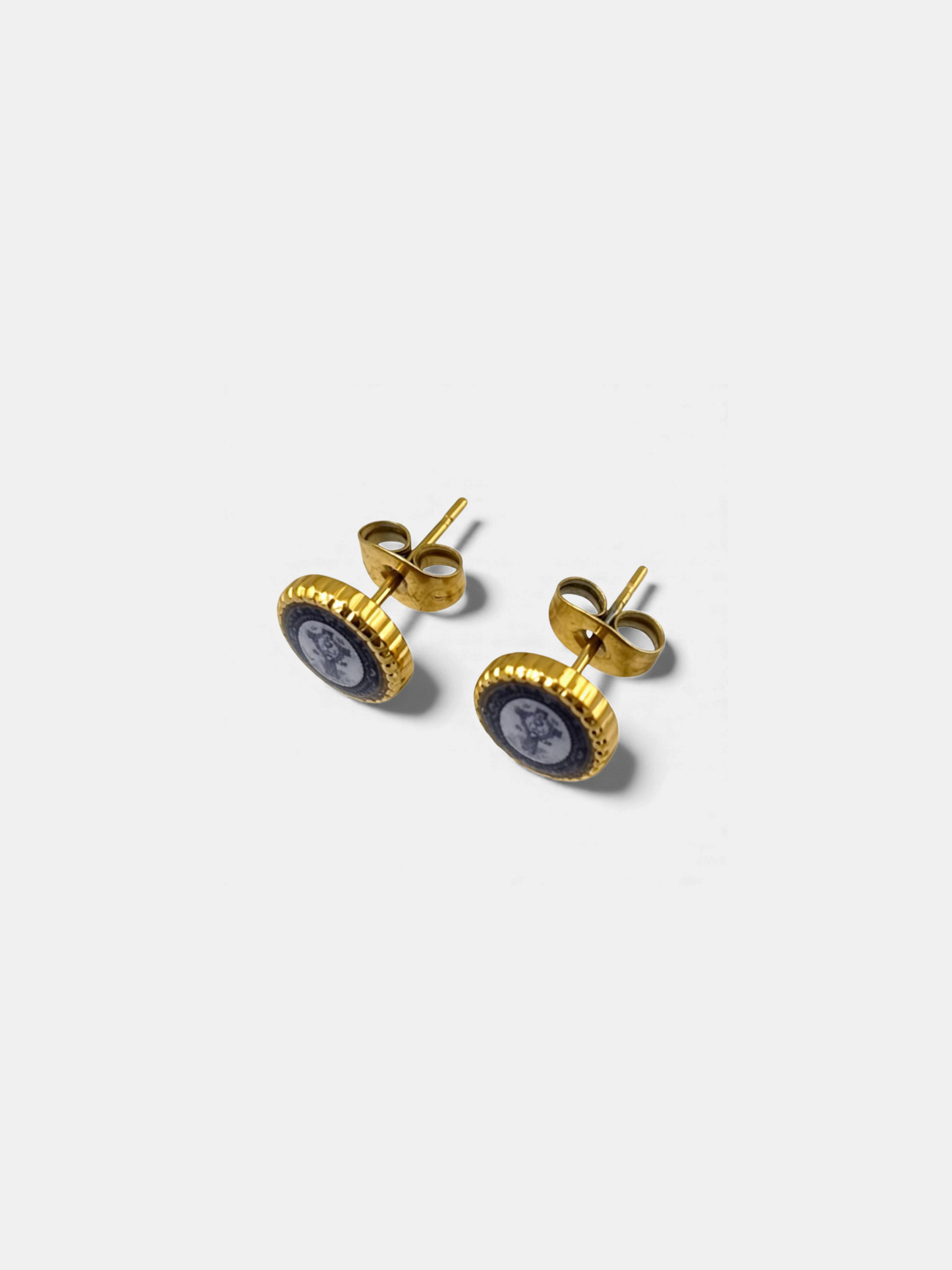 Vintage-inspired gold stud earrings with ornamental design and cross icon