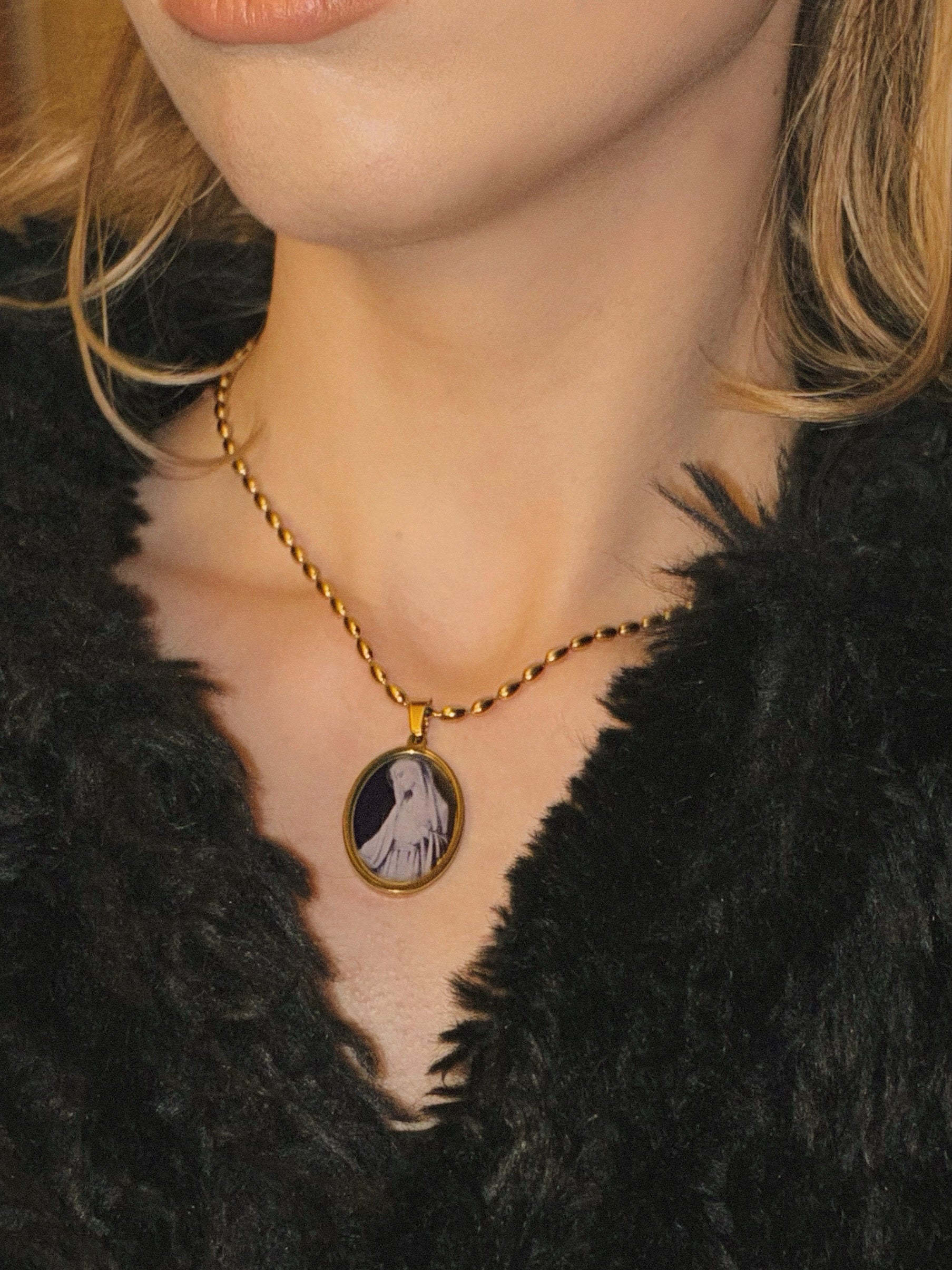Handcrafted gold-filled necklace featuring a tiny glass-like cabochon of the Virgin Mary.