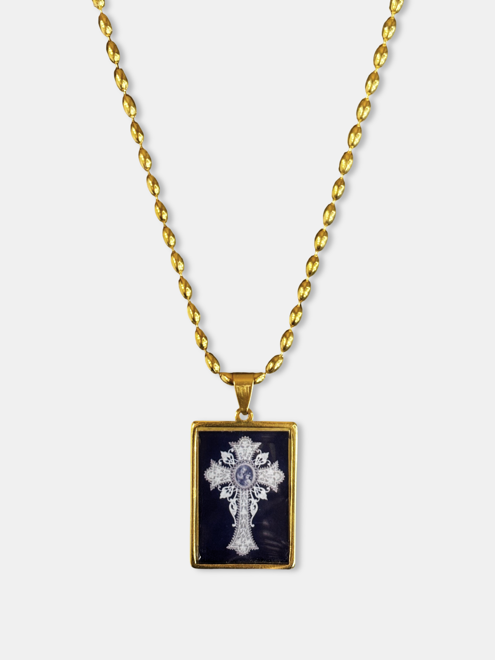 Elegant gold-filled chain with a black enamel pendant showcasing a baroque-inspired cross.