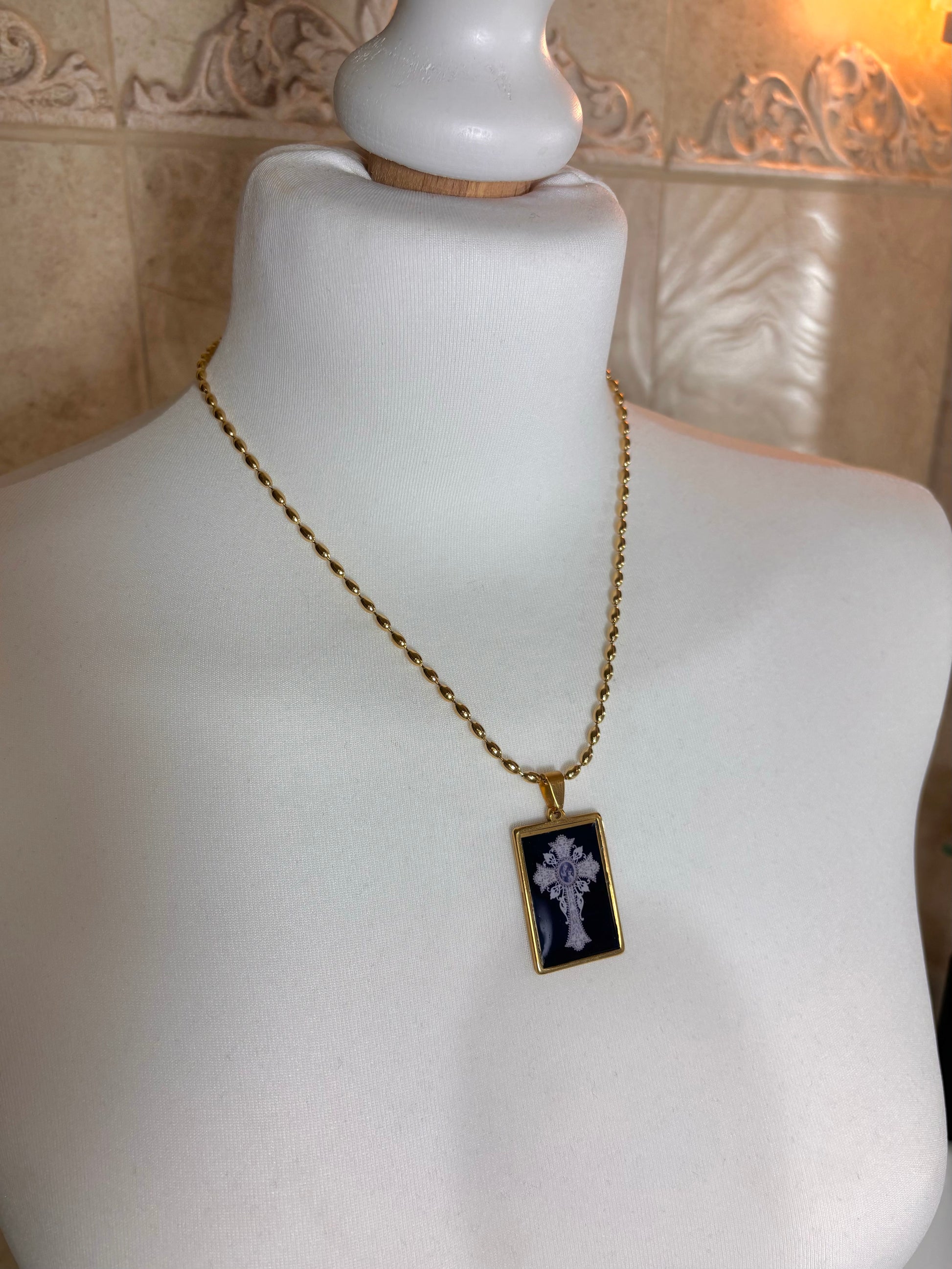 Designer pendant necklace in gold and black tones